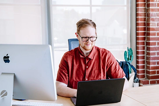 tg employee working at desk in office